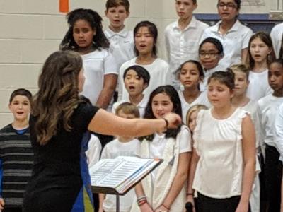 Ms. Dowd leading choral students 