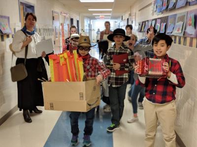 image of students dressed up for Pioneer Day while working on activities