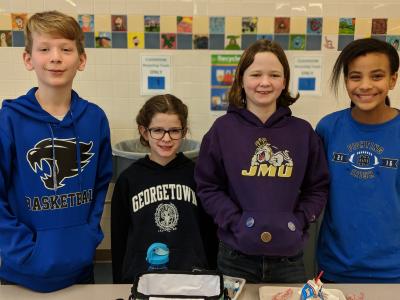 image of 4 students with jerseys