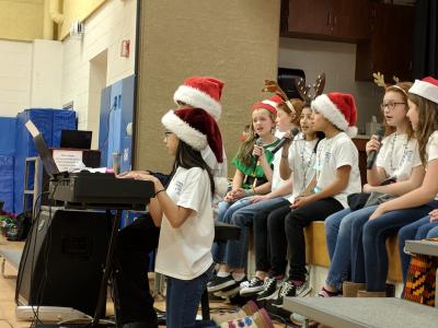 winter concert students singing and playing instruments